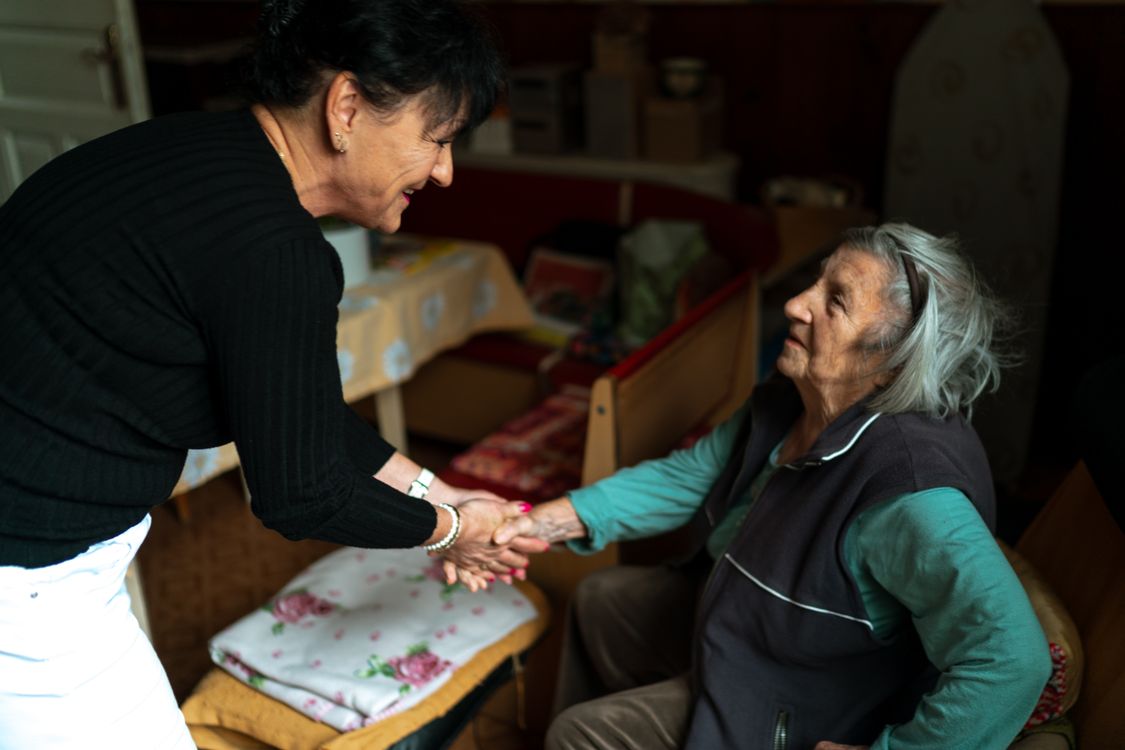 Care professional greeting an older adult during an in-home visit