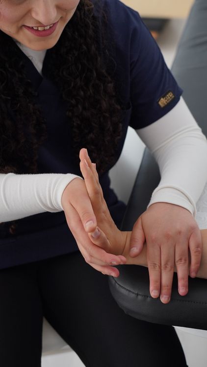 Therapist providing hands-on rehabilitation for hand movement